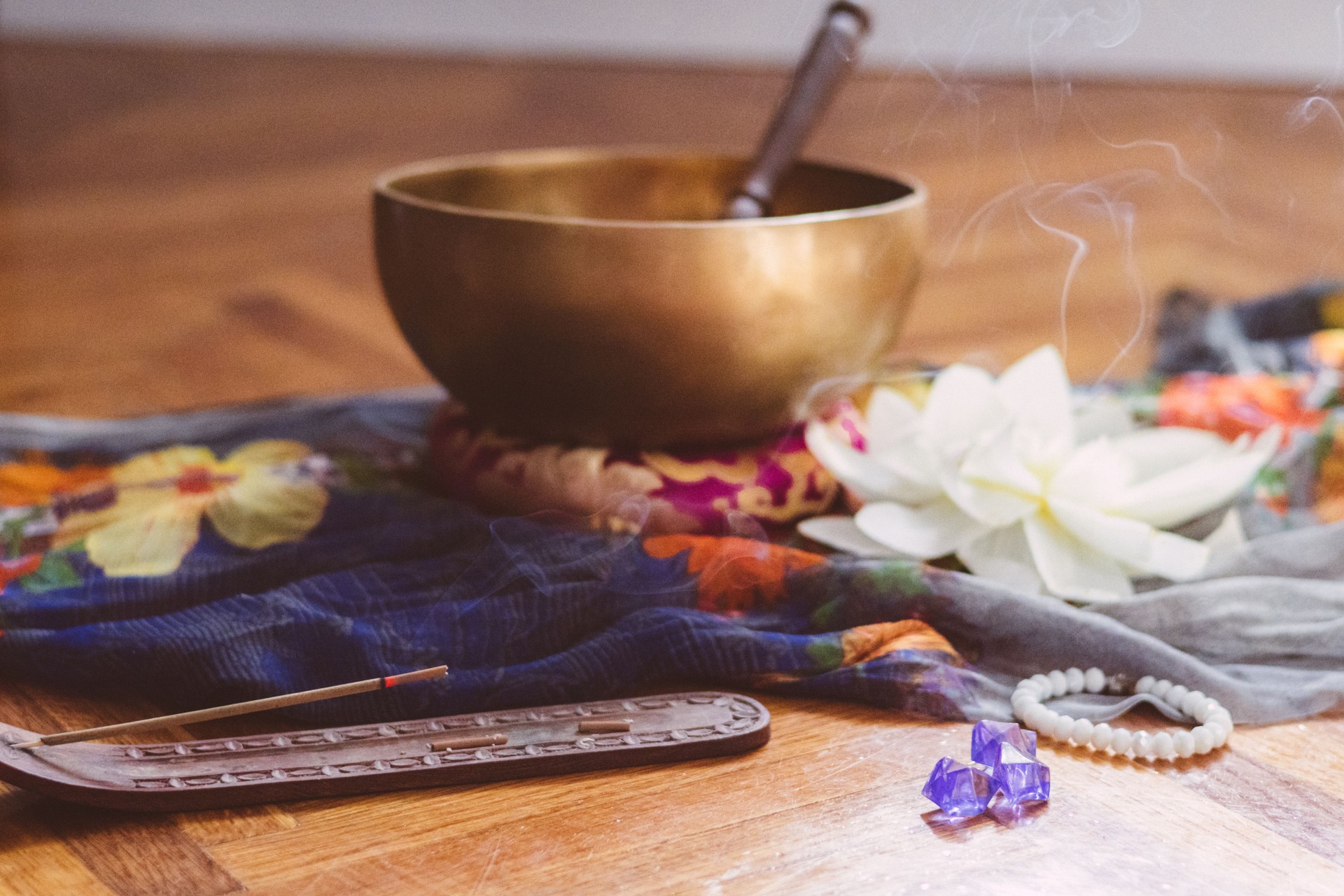 Healing Tibetan singing bowl, Indian incense stick in stick holder burning with smoke and lotus flower on the beautiful saree. Meditation, destress, relaxation, mental health, spiritual practices. Energetical power concept