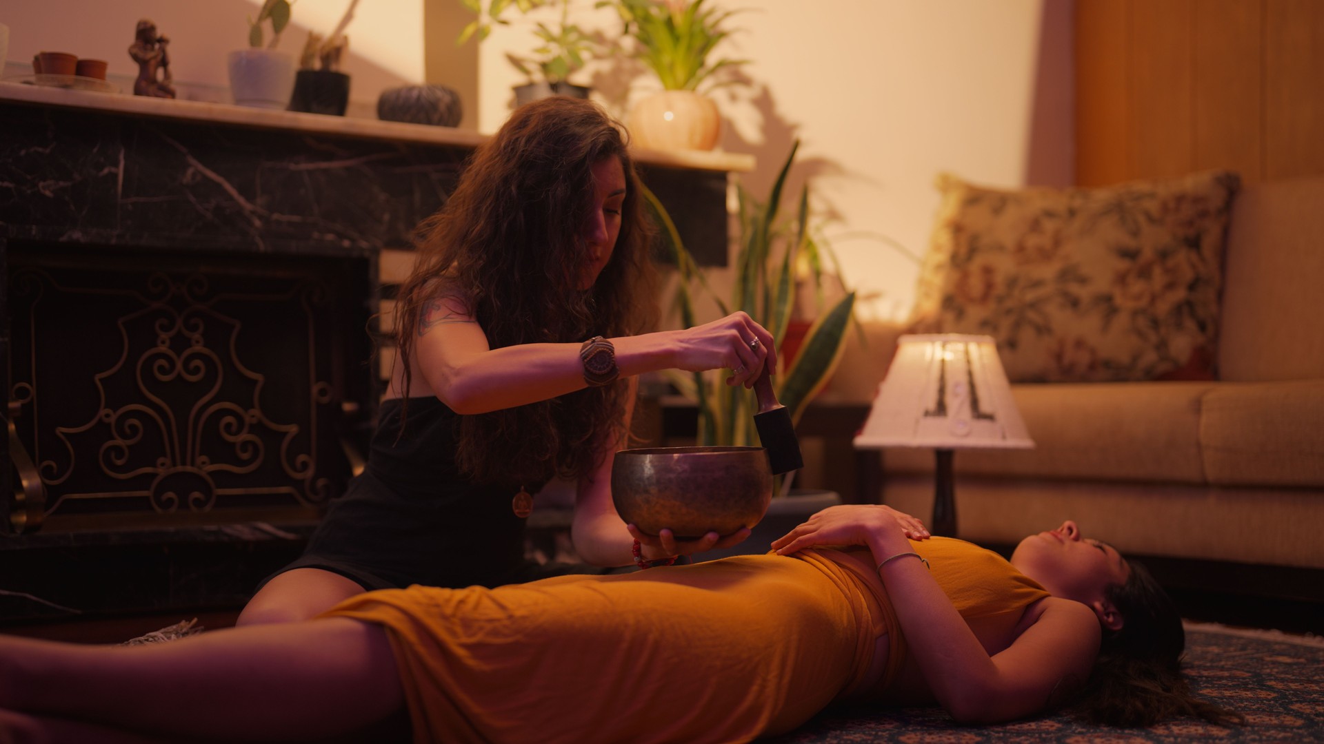 Woman using Tibetan bowl for music and sound healing therapy session